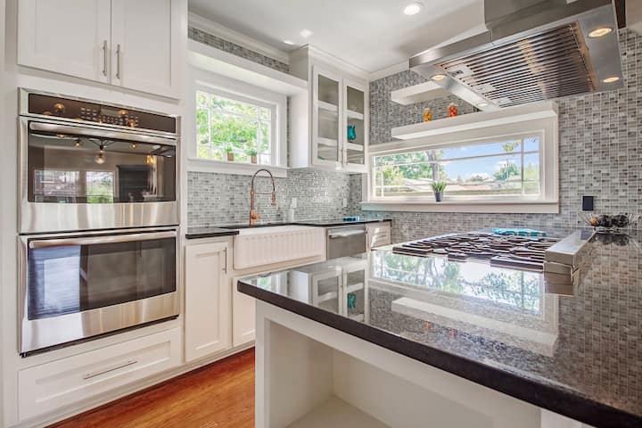 An image of a modern kitchen with sleek appliances, featuring a gas stove, refrigerator, and built-in microwave in Melbourne